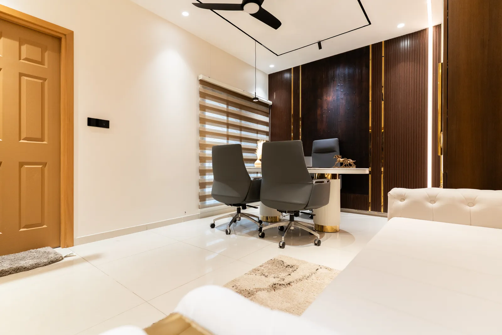 Home office with walnut wall panelling and executive chairs — Abhishek's Residence